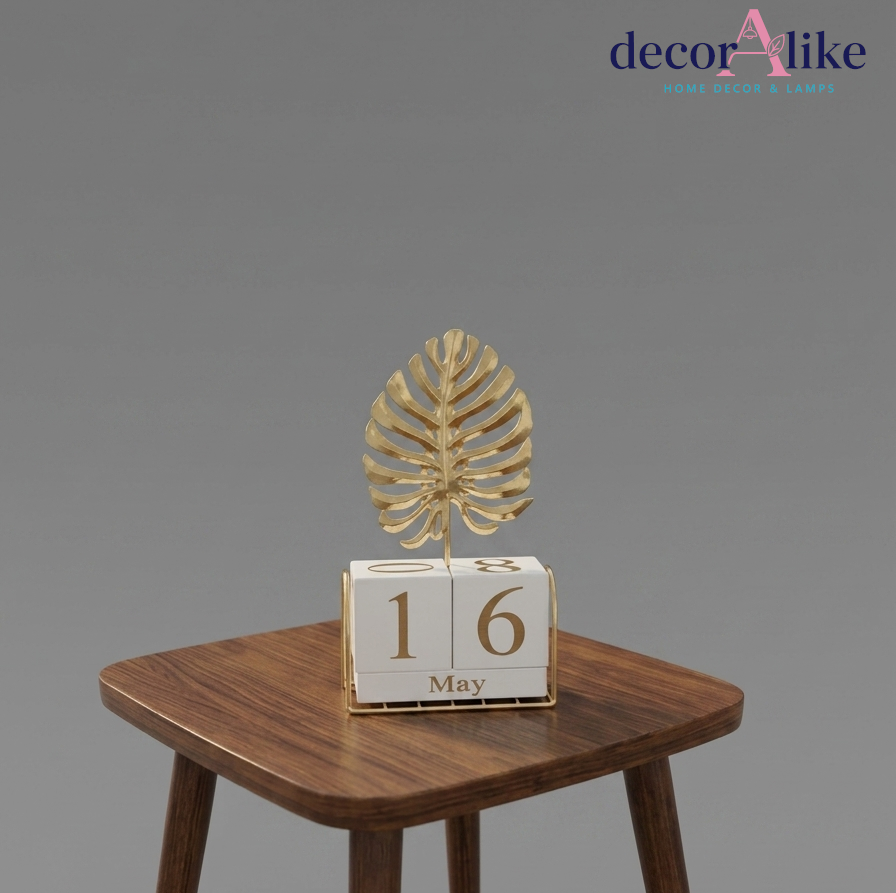 Perpetual desk calendar with gold monstera leaf topper on side table – Decoralike Lahore