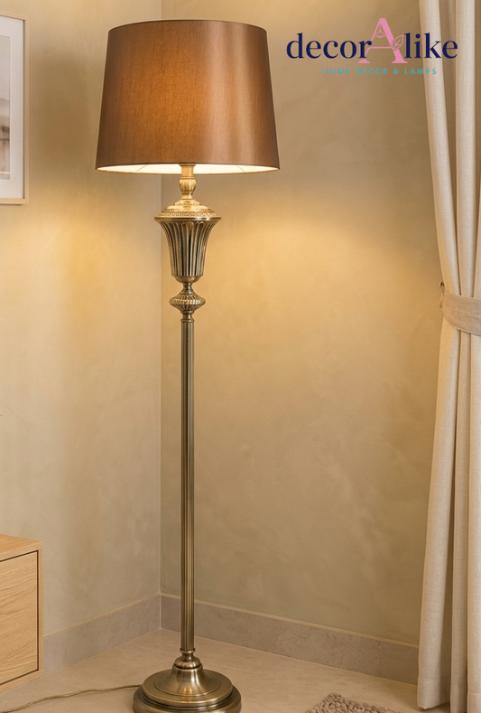 Antique brass fluted floor lamp with bronze satin shade in a drawing room corner