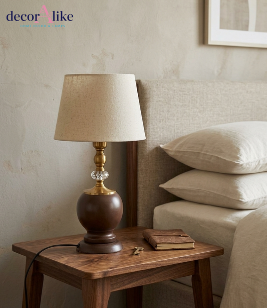 Elegant brown urn table lamp with brass and crystal accents beige linen shade on wooden table - DecorAlike Pakistan
