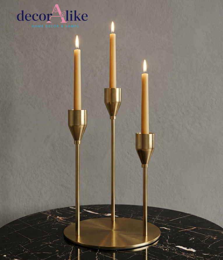 Brass three-arm taper candle holder with staggered heights on round base