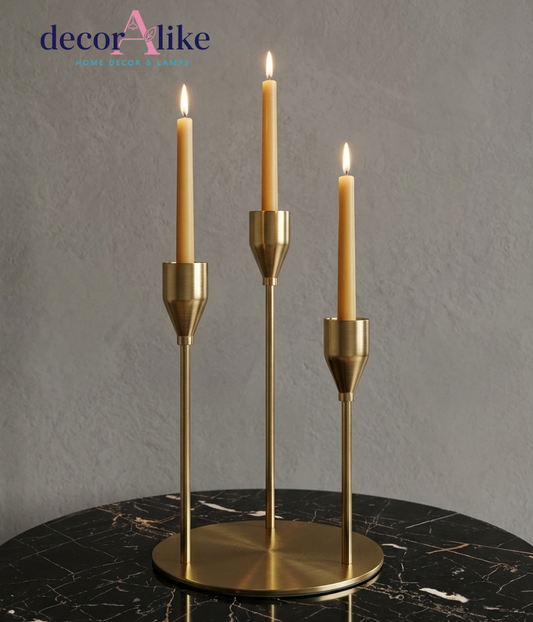 Brass three-arm taper candle holder with staggered heights on round base