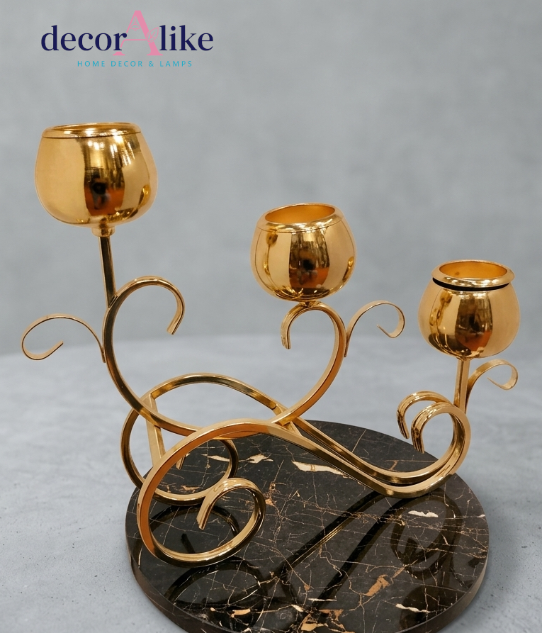 Gold scroll tealight candle holder with three cups on black marble base