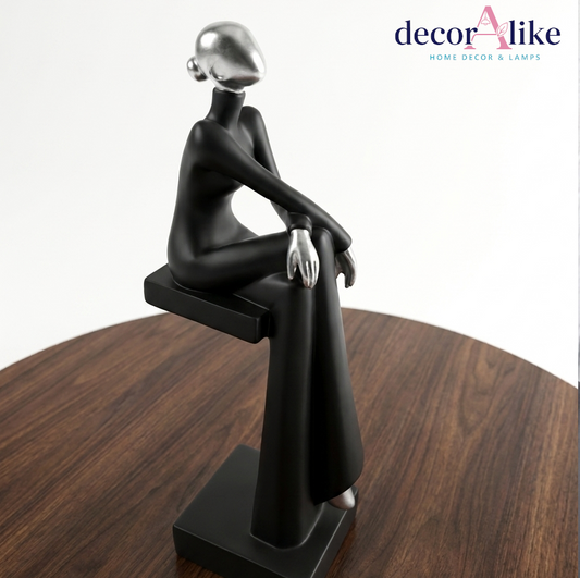 Buy the Sitting Lady Statue at DecorAlike. Premium modern abstract black & chrome silver female sculpture. Perfect luxury table decoration piece in Pakistan.