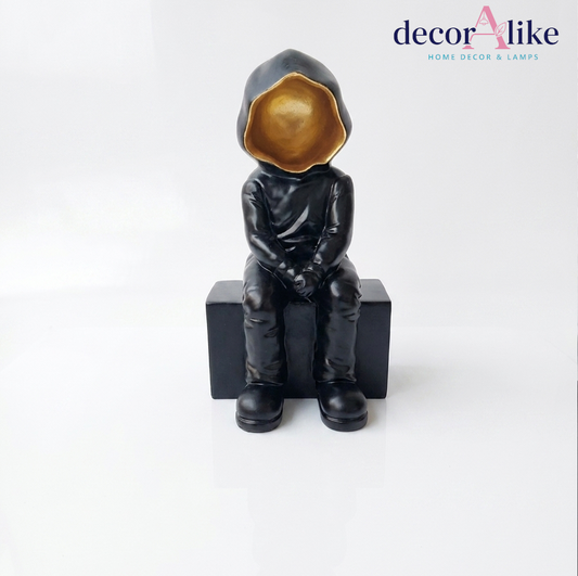Seated hooded figure sculpture with gold interior – Decoralike Lahore