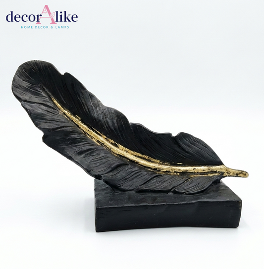 Reclining black feather sculpture with gold quill accent – Decoralike Lahore
