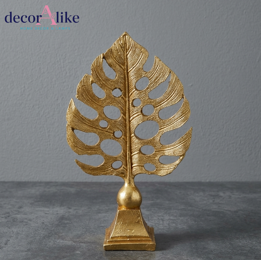 Gold monstera leaf sculpture on pedestal base – Decoralike Lahore