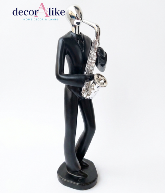 Abstract saxophone player sculpture in matte black with chrome head – Decoralike Lahore