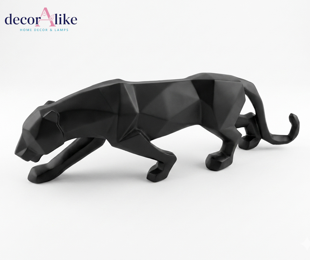 A modern low-poly geometric black panther figurine, captured in a side profile against a clean white background. The 'decorAlike' brand logo is visible in the top-left corner.