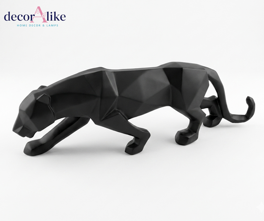 A modern low-poly geometric black panther figurine, captured in a side profile against a clean white background. The 'decorAlike' brand logo is visible in the top-left corner.