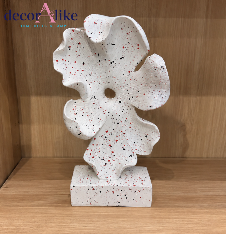 Modern white abstract flower decorative sculpture with red and black speckles