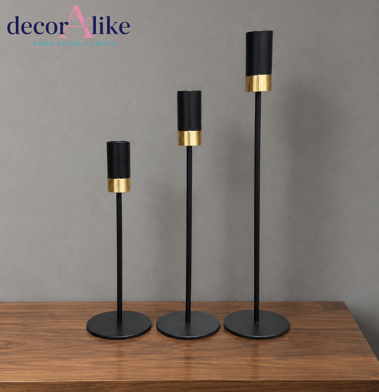 Set of three modern black and gold decorative candle holders in different heights
