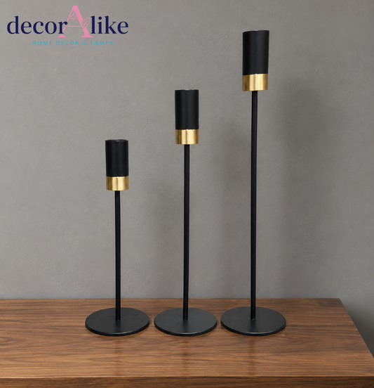 Set of three modern black and gold decorative candle holders in different heights