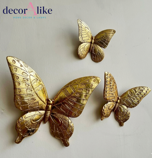 Set of three gold butterfly wall decor pieces with detailed wings