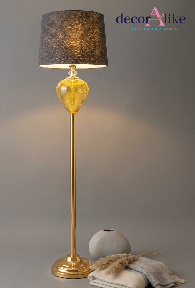 Gold crystal floor lamp with amber glass teardrop base 
and textured charcoal shade glowing in living room corner