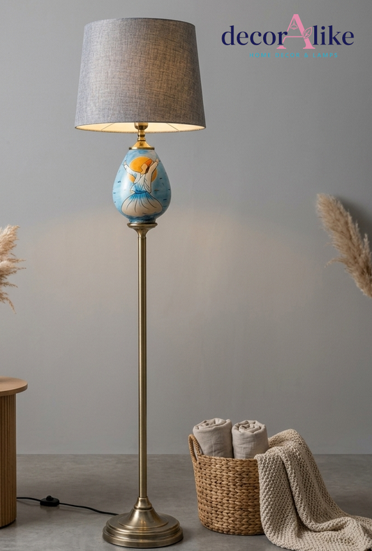 Hand-painted whirling dervish floor lamp with brass pole and pleated grey shade in a living room corner