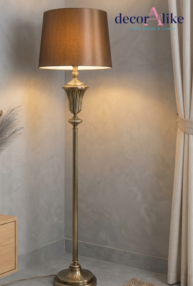 Antique brass fluted floor lamp with bronze satin shade in a drawing room corner