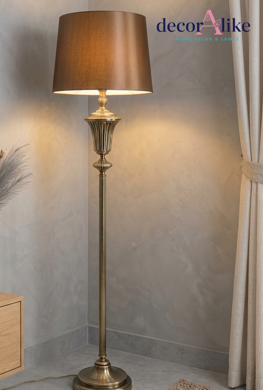 Antique brass fluted floor lamp with bronze satin shade in a drawing room corner