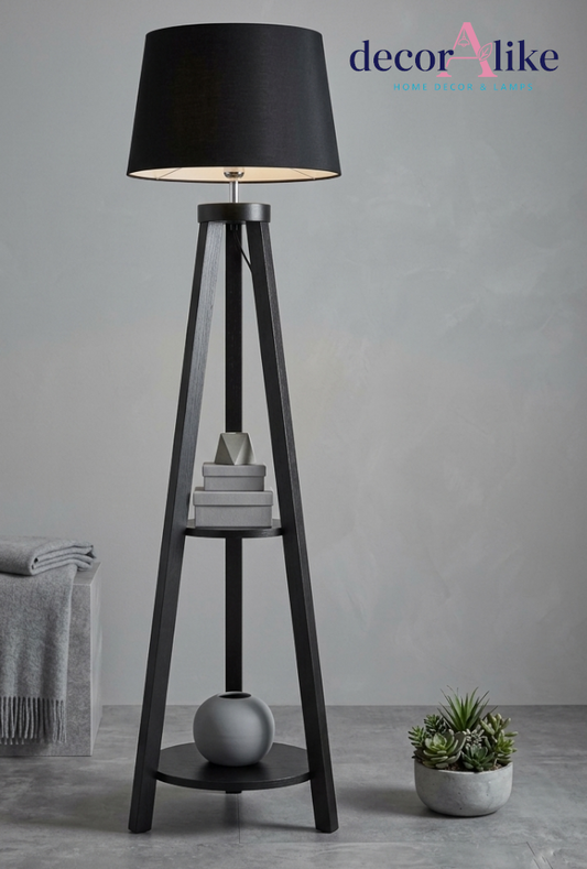 Black wooden tripod floor lamp with two built-in shelves and black drum shade