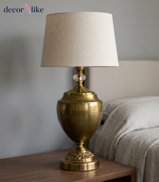 Close-up of antique brass urn body, ornate base and crystal accent on DecorAlike luxury table lamp