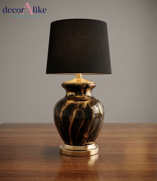 Black and gold marble ceramic table lamp with black fabric drum shade and gold metal accents on wooden table – DecorAlike