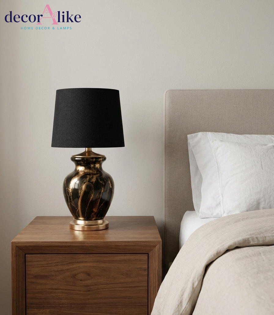 Black and gold marble ceramic table lamp with black fabric drum shade and gold metal accents on wooden table – DecorAlike