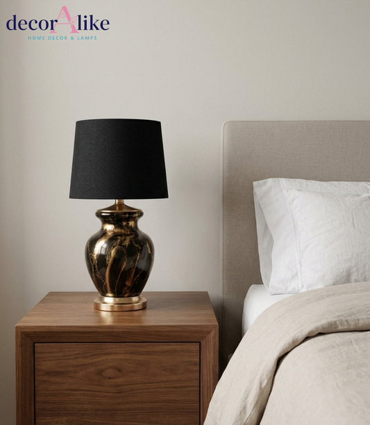 Black and gold marble ceramic table lamp with black fabric drum shade and gold metal accents on wooden table – DecorAlike