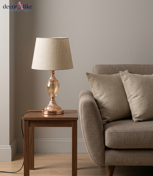 Rose gold table lamp with clear bubble glass base and cream linen shade — glass bedside lamp Pakistan