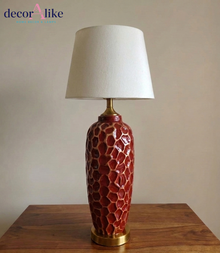 Tall red ceramic table lamp with carved honeycomb texture and gold base — statement living room lamp Pakistan