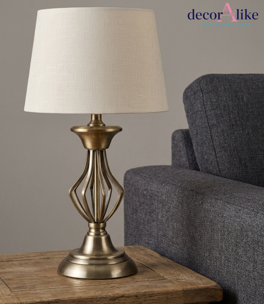 Antique brass cage table lamp with open metal base and ivory linen shade — metal bedside lamp Pakistan