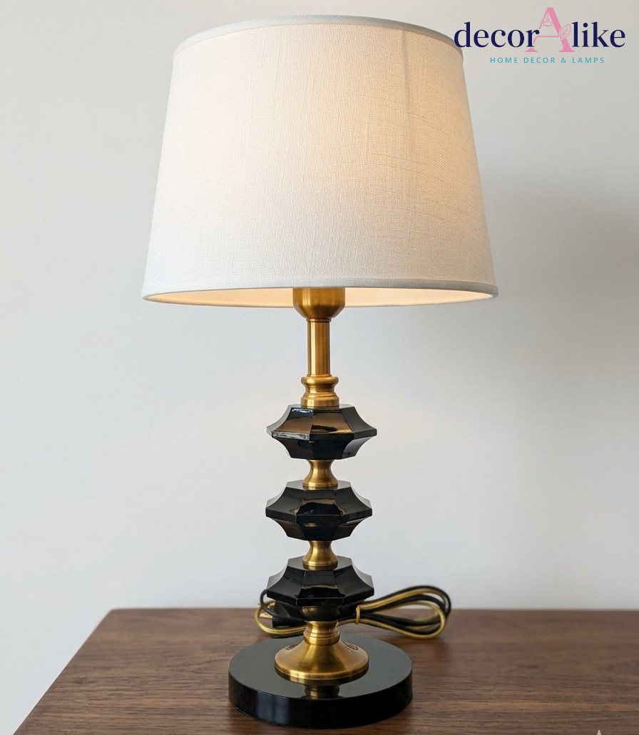 Black crystal table lamp with gold stem and white linen shade on wooden side table — modern bedside lamp Pakistan