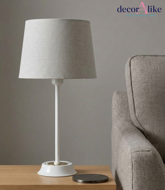 Minimalist matte white slim stem table lamp with brass ring detail and grey linen shade on an oak console