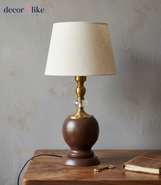 Elegant brown urn table lamp with brass and crystal accents beige linen shade on wooden table - DecorAlike Pakistan