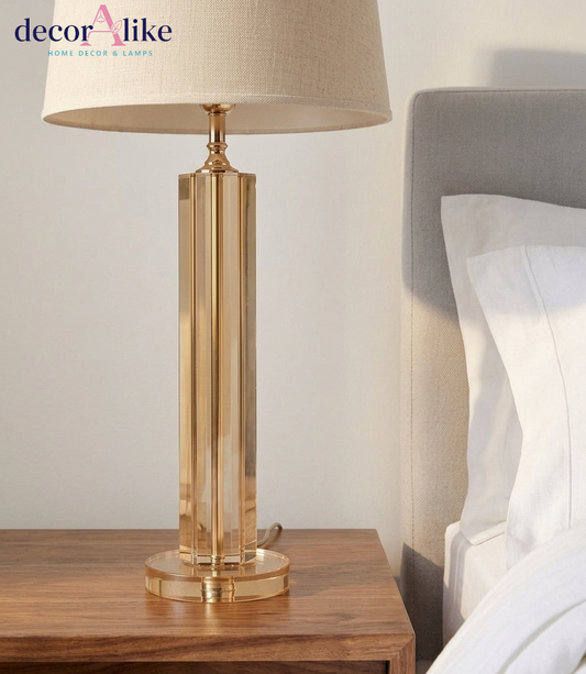 Amber crystal column table lamp with faceted panels, crystal base and ivory linen drum shade