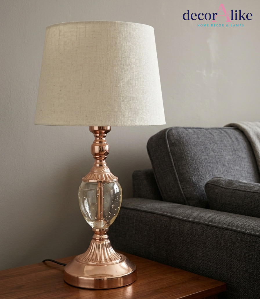 Rose gold table lamp with clear bubble glass base and cream linen shade — glass bedside lamp Pakistan