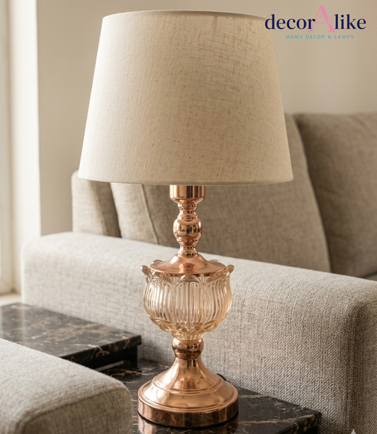 Rose gold fluted glass table lamp with beige linen shade on a marble side table in a neutral living room