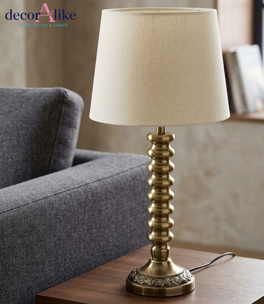 Ribbed antique brass table lamp with cream linen shade on wooden side table — Decoralike Pakistan
