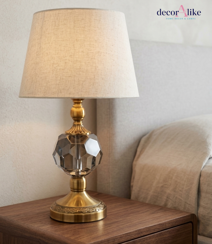 Crystal ball table lamp with antique brass base and beige linen shade on wooden nightstand — small bedside lamp Pakistan